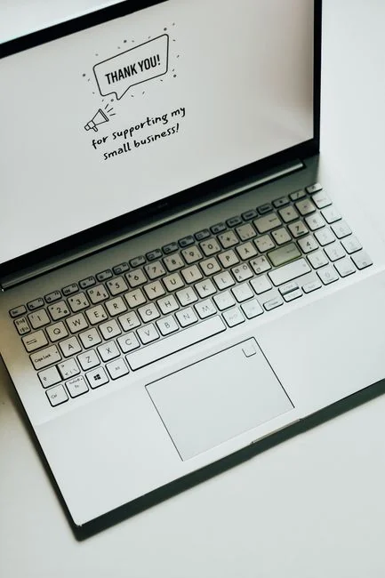 Top view of a sleek modern office desk with a laptop, tablet, and accessories.